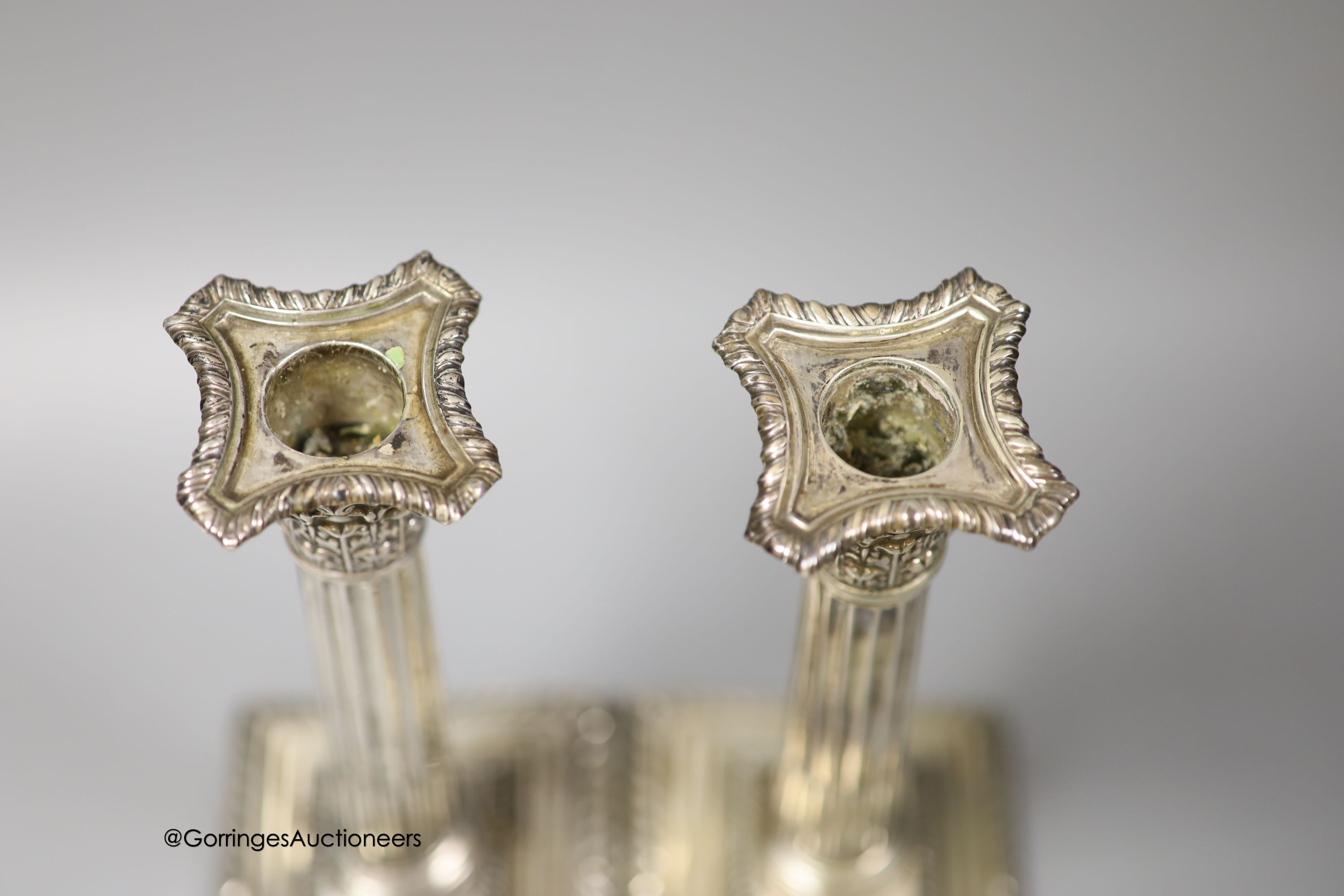 A pair of Edwardian silver corinthian column candlesticks, Walter Latham & Son, Sheffield, 1904, 24.5cm, weighted (a.f.).